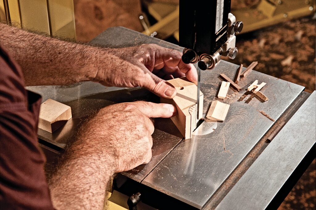 hands showing wood cuts using a band saw